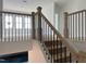 Elegant staircase features wooden banisters with metal accents and natural lighting at 4317 Emeline Way # 12, Fuquay Varina, NC 27526