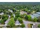 An aerial view of a neighborhood with mature trees, streets, tennis courts and community features at 4902 Cedar Glen Dr, Durham, NC 27713