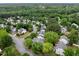 Aerial view of neighborhood homes surrounded by dense trees and winding roads at 4902 Cedar Glen Dr, Durham, NC 27713