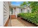 Front entrance featuring a brick staircase, covered porch, and neatly trimmed landscaping at 4902 Cedar Glen Dr, Durham, NC 27713