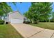 Front exterior of home with long driveway, garage, lawn, and mature trees at 4902 Cedar Glen Dr, Durham, NC 27713