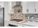 This kitchen boasts stainless appliances, white cabinets, and a stylish backsplash at 4902 Cedar Glen Dr, Durham, NC 27713