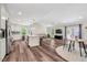 Open-concept living room and kitchen with hardwood floors and access to the outside at 4902 Cedar Glen Dr, Durham, NC 27713