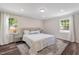 Bright main bedroom with neutral colors, hardwood floors, and lots of natural light at 4902 Cedar Glen Dr, Durham, NC 27713