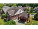 Aerial view of a brick home with a landscaped yard, driveway, and surrounding neighborhood at 5619 Bennettwood Ct, Raleigh, NC 27612