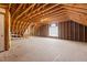 The attic features unfinished wood flooring, walls, and ceiling and an abundance of overhead room at 5619 Bennettwood Ct, Raleigh, NC 27612