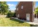 Landscaped backyard featuring brick patio and well-maintained lawn area at 5619 Bennettwood Ct, Raleigh, NC 27612