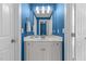 The bathroom features blue painted walls, tile flooring, and a white single sink vanity with white fixtures at 5619 Bennettwood Ct, Raleigh, NC 27612