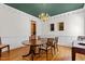 Traditional dining room boasts hardwood floors, elegant chandelier, and classic wainscoting details at 5619 Bennettwood Ct, Raleigh, NC 27612