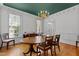 Formal dining room with hardwood floors, traditional furniture, a chandelier, and wainscoting at 5619 Bennettwood Ct, Raleigh, NC 27612