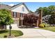 Rear exterior view of a brick home with a landscaped yard and driveway at 5619 Bennettwood Ct, Raleigh, NC 27612