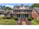 Charming two-story brick home with a blue front door, black shutters, and manicured landscaping at 5619 Bennettwood Ct, Raleigh, NC 27612