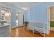 Charming foyer with blue walls, light hardwood floors, and a bench for comfortable entry at 5619 Bennettwood Ct, Raleigh, NC 27612