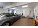 Garage interior with a gray car, storage cabinets, and an organized workspace at 5619 Bennettwood Ct, Raleigh, NC 27612