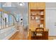 Elegant hallway with a built-in desk, hardwood floors, and views of the staircase and front door at 5619 Bennettwood Ct, Raleigh, NC 27612