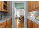View from kitchen to dining room showing marble counters, warm wood cabinets, and hardwood flooring at 5619 Bennettwood Ct, Raleigh, NC 27612