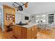 Beautiful kitchen island with marble countertops, an overhead rack, and a view of the breakfast nook at 5619 Bennettwood Ct, Raleigh, NC 27612