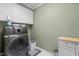The laundry room features modern washer and dryer units, practical storage cabinets, and white tile flooring at 5619 Bennettwood Ct, Raleigh, NC 27612