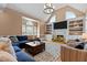 Bright living room with vaulted ceilings, built-in shelving, and a cozy seating area at 5619 Bennettwood Ct, Raleigh, NC 27612