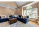 Spacious living room features a large blue sectional sofa, multiple pillows, and hardwood floors at 5619 Bennettwood Ct, Raleigh, NC 27612