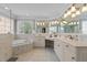 A primary bath with a tub, glass shower, white cabinets and counters, and tile flooring at 5619 Bennettwood Ct, Raleigh, NC 27612