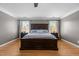 This spacious main bedroom includes a large bed, hardwood floors, and dual windows at 5619 Bennettwood Ct, Raleigh, NC 27612