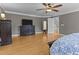 Spacious primary bedroom features a ceiling fan, hardwood floors, and a dresser at 5619 Bennettwood Ct, Raleigh, NC 27612
