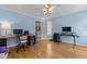 The office features hard wood floors, soft-blue painted walls, with multiple desks and seating at 5619 Bennettwood Ct, Raleigh, NC 27612