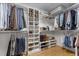 Walk-in closet featuring custom shelving for shoes, folded clothes, and hanging items at 5619 Bennettwood Ct, Raleigh, NC 27612