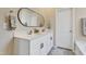 Bathroom with a double vanity, modern fixtures, and a large framed mirror over the sinks at 636 Ginger Mint Cir, Knightdale, NC 27545
