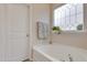 Relaxing bathtub nook with decorative window, towel, and ledge for plants and accessories at 636 Ginger Mint Cir, Knightdale, NC 27545