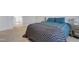 Bedroom featuring plush carpeting, a bed with a throw blanket, and light-filled ambiance at 636 Ginger Mint Cir, Knightdale, NC 27545