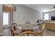 Cozy dining area with a glass-top table and rattan chairs, flooded with natural light at 636 Ginger Mint Cir, Knightdale, NC 27545