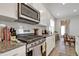 Well-equipped kitchen with stainless steel appliances, granite counters, and classic white cabinets at 636 Ginger Mint Cir, Knightdale, NC 27545