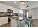 Modern kitchen features a large granite island, stainless steel appliances, and white cabinetry at 636 Ginger Mint Cir, Knightdale, NC 27545