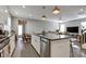 Open kitchen design with a large island, stainless steel appliances, and view to the Gathering room at 636 Ginger Mint Cir, Knightdale, NC 27545