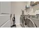 Functional laundry room with modern washer and dryer and ample shelving at 636 Ginger Mint Cir, Knightdale, NC 27545