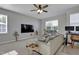 Comfortable living room with neutral colors, ceiling fan, and large screen tv at 636 Ginger Mint Cir, Knightdale, NC 27545