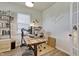 Bright home office features a wood desk, natural light from the window, and plenty of storage shelves at 636 Ginger Mint Cir, Knightdale, NC 27545