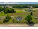 Aerial view showcasing a fenced home on a large lot with surrounding greenery and open fields at 640 Short Journey Rd, Smithfield, NC 27577