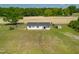 Charming home boasts new roof, white siding, and ample yard space, surrounded by lush trees at 640 Short Journey Rd, Smithfield, NC 27577