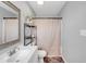 Bathroom features a vanity sink, toilet, mirror, storage shelves, and a shower with a striped curtain at 640 Short Journey Rd, Smithfield, NC 27577