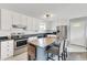 Modern kitchen with stainless steel appliances, white cabinets, and central island with seating at 640 Short Journey Rd, Smithfield, NC 27577