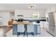 Bright kitchen features a central island, white cabinets, stainless steel appliances, and stylish backsplash at 640 Short Journey Rd, Smithfield, NC 27577