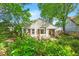 Rear view of home highlighting deck, mature landscaping, and outdoor dining area at 708 Mills St, Raleigh, NC 27608
