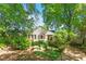Cozy backyard featuring mature trees and greenery and a stone path leading to the home at 708 Mills St, Raleigh, NC 27608