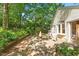 Backyard featuring a wooden deck, fire pit, and mature landscaping for privacy at 708 Mills St, Raleigh, NC 27608