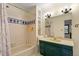 Classic bathroom design with a bathtub, vanity, and decorative blue tile accents at 708 Mills St, Raleigh, NC 27608