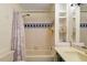Bright bathroom with a shower/tub combo, vanity, and built-in storage shelves at 708 Mills St, Raleigh, NC 27608