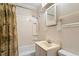 Clean bathroom with shower-tub combination, sink, and wainscoting at 708 Mills St, Raleigh, NC 27608